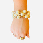 Set of 3 water-resistant pearl and gold beaded stretch bracelets with 14mm pearls and 5mm gold beads.