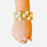 Set of 3 water-resistant pearl and gold beaded stretch bracelets with 14mm pearls and 5mm gold beads.
