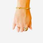 Waterproof stainless steel 4mm gold beaded bracelet with 8mm gold bead accent.