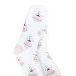 A pair of plush, soft crew socks with a repeating pattern of pastel-colored Christmas ball ornaments.