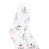 A pair of plush, soft crew socks with a repeating pattern of pastel-colored Christmas ball ornaments.