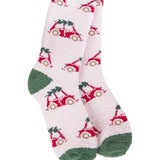 A pair of plush, soft crew socks featuring a repeating pattern of a vintage red bug car with a Christmas tree on its roof. The socks have solid green heels and toes.