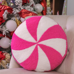 Round pink peppermint swirl pillow, 14-inch diameter, soft and festive holiday decor.