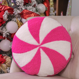 Round pink peppermint swirl pillow, 14-inch diameter, soft and festive holiday decor.