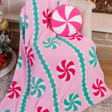 Soft pink blanket with peppermint candy designs, perfect for cozying up and adding festive charm to your holiday décor.