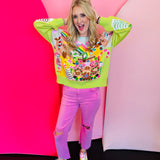 Lime green Christmas sweater with sequin gingerbread village, candy canes, nutcrackers, and rainbows.