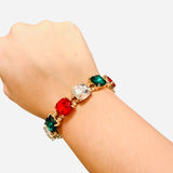 Gold stretch bracelet with red, green, and clear rhinestones.