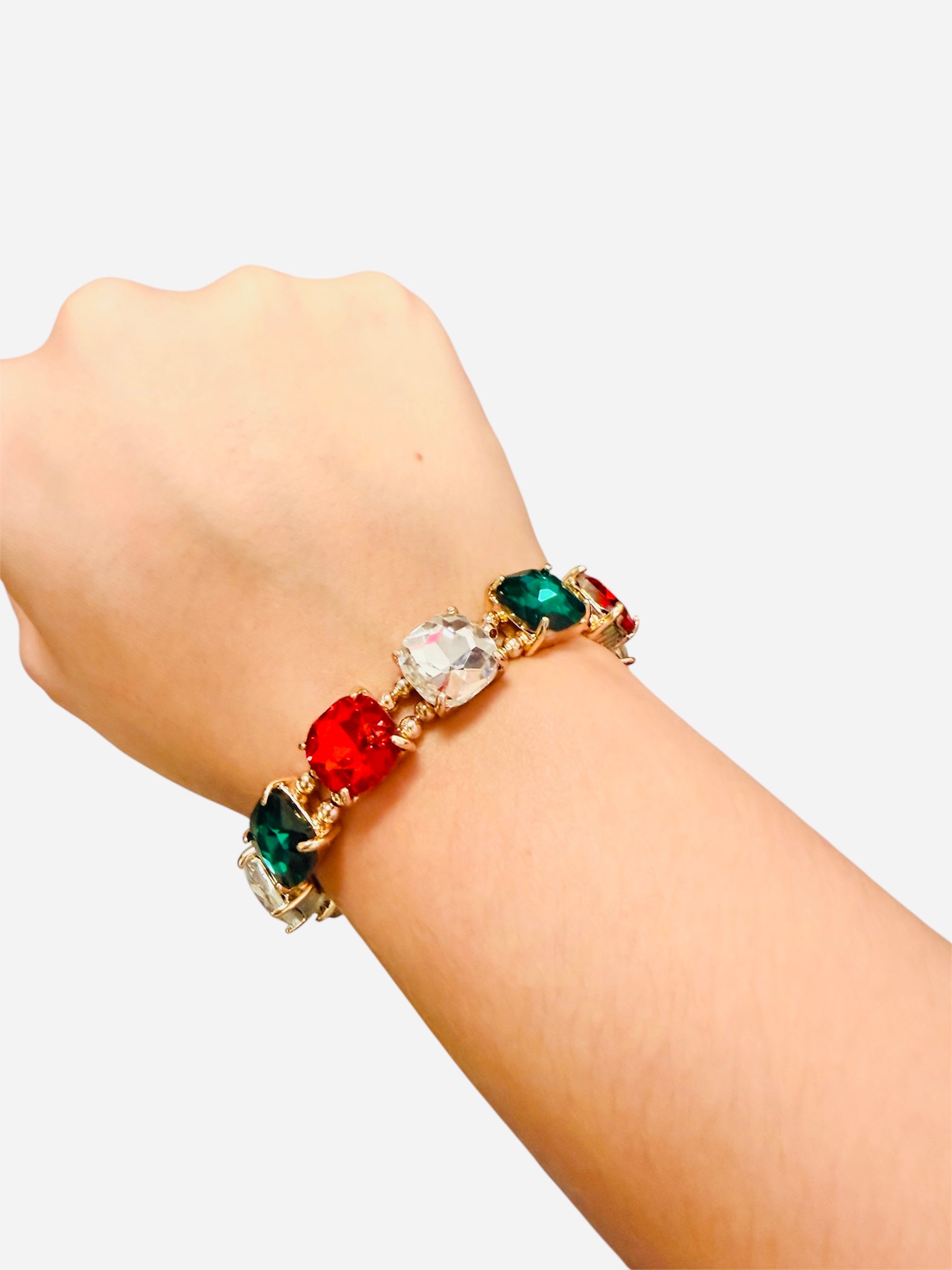 Gold stretch bracelet with red, green, and clear rhinestones.