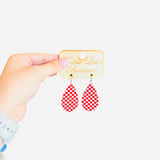 Red and white checkered teardrop acrylic earrings with glossy finish, lightweight and bold.