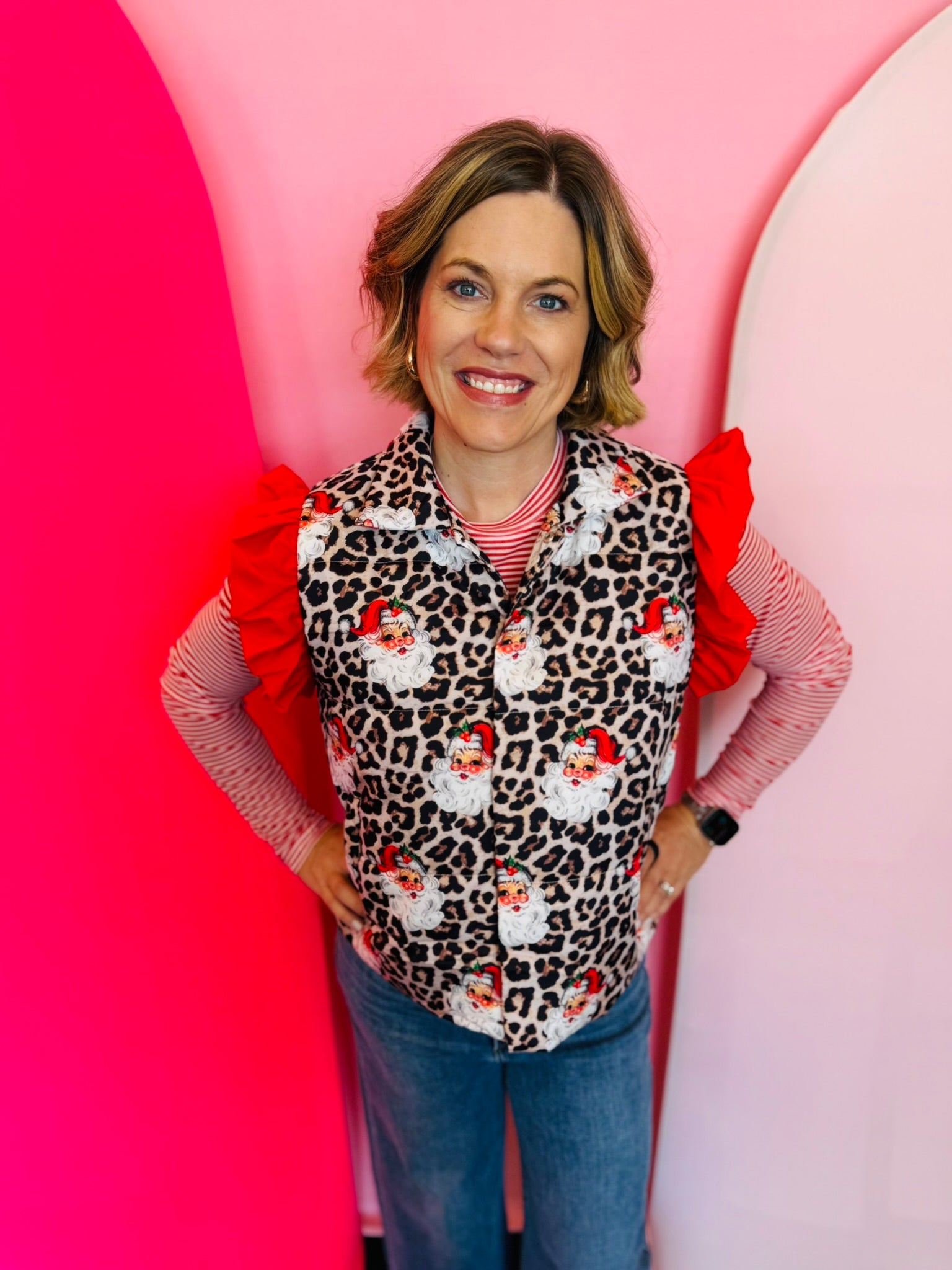 Festive leopard-print puffer vest with santa accents, perfect for layering and staying warm.