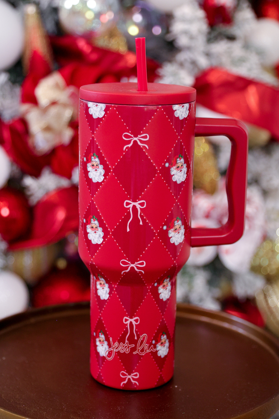 40oz tumbler with Santa design, bow accents, handle, and reusable straw.