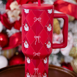 40oz tumbler with Santa design, bow accents, handle, and reusable straw.