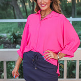 Solid navy colored skort with elastic back waistband, drawstring, built-in shorts, and side pockets in lightweight polyester-spandex fabric.