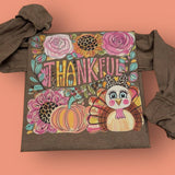 Espresso long sleeve tee with “Thankful” floral pumpkin and leopard turkey graphic.
