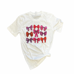 White tee with pink bow print design.