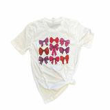 White tee with pink bow print design.