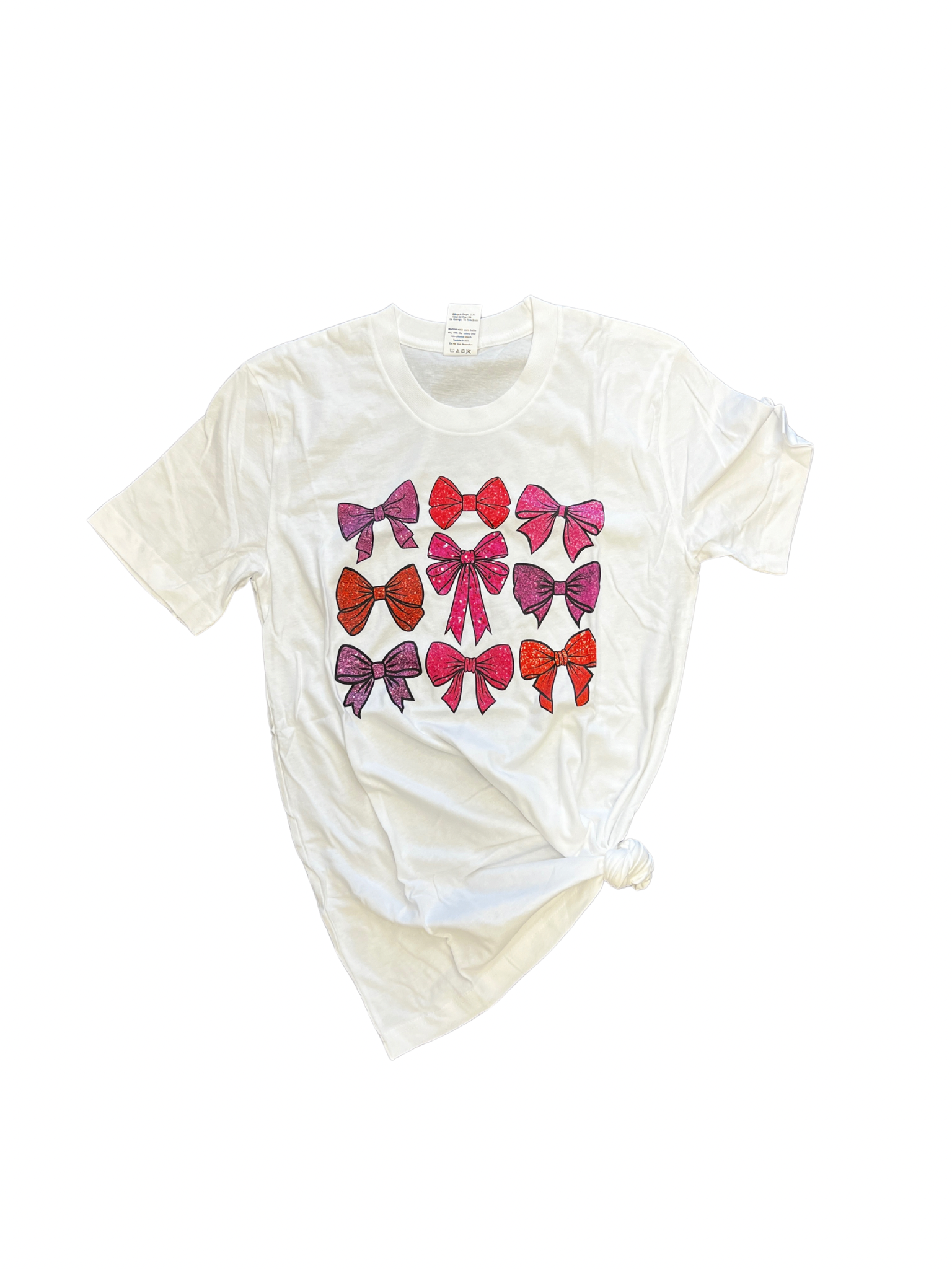 White tee with pink bow print design.