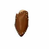 Camel-colored slide sandals with sleek silhouette and spikey stud embellishments along the edge