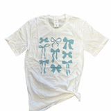 White tee with blue bow print design.