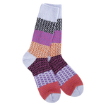 A pair of plush, soft crew socks featuring a patchwork design with various patterns like stripes and chevrons in shades of purple, red, orange, and lavender.