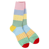 World’s Softest Socks geometric patterned crew socks in pink, blue, yellow, and green  with red toes and gold heels.