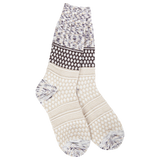 A pair of plush, soft crew socks with a patchwork design featuring various geometric patterns in shades of cream, beige, and brown.