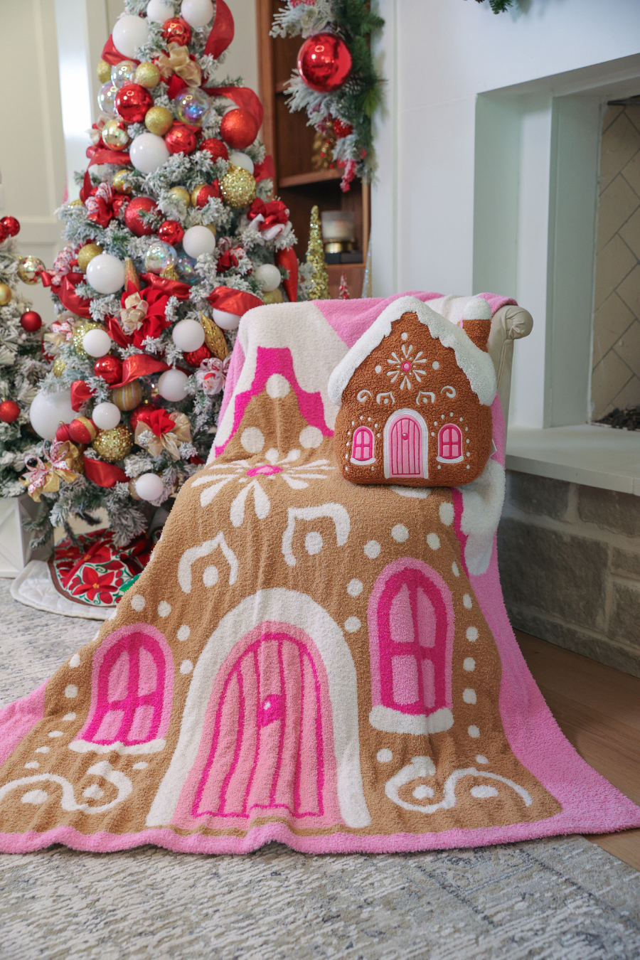 Pink blanket with gingerbread house and candy-colored details, 50x57 inches.
