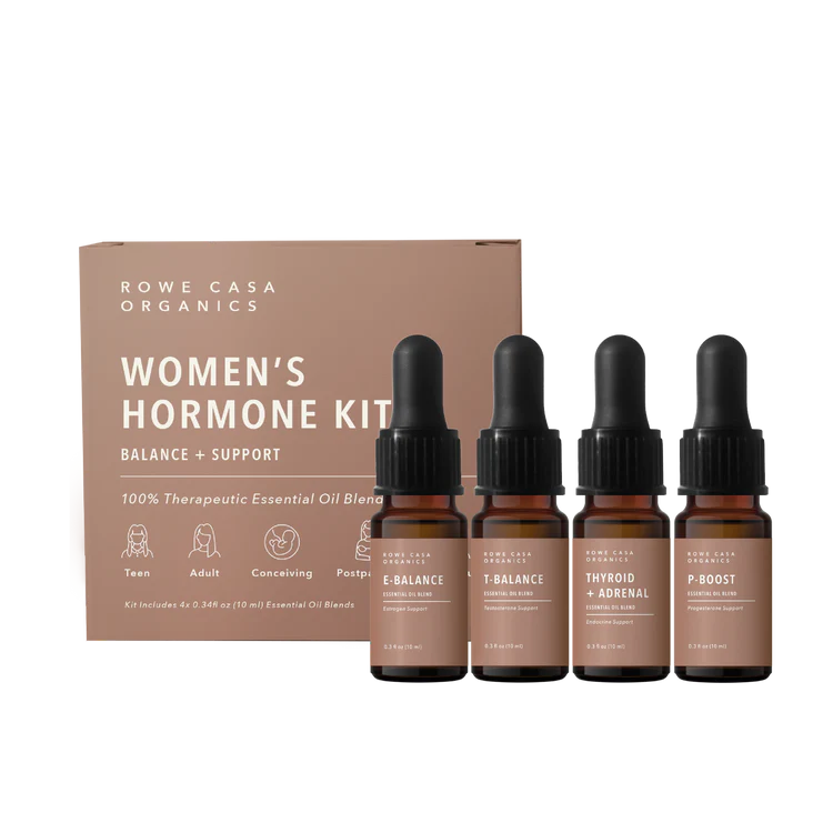 Balanced Hormone Essential Oil Kit with four 10ml roll-ons labeled E-Balance, P-Boost, T-Balance, and Thyroid + Adrenal Support, displayed upright next to the product instruction insert