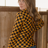 Gold and black checkered pullover with collared neckline, quarter-zip front, and kangaroo pocket, laid flat to highlight bold colors and design.