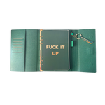 Inside view of green clutch folio journal with calender and matching pen. 'FUCK IT UP' gold foil text.