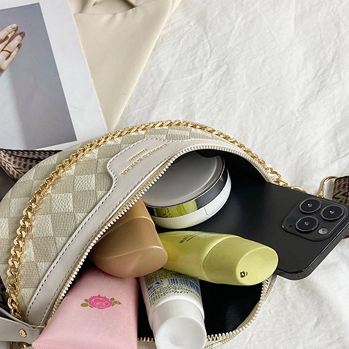 Open view of the cream checkered fanny pack with gold chain accent