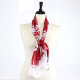 Crimson and cream Oklahoma Sooners knit scarf with printed school song lyrics and fringed edges, showcasing school pride in a stylish and cozy way.