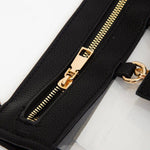 black clear crossbody bag with gold hardware and built-in sunglasses holder—stylish, functional, and stadium-ready.