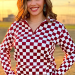 Maroon and white checkered pullover with a collared neckline, quarter-zip front, and kangaroo pocket, laid flat to showcase the bold pattern and design.