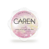 A pink, soap-infused sponge with the word "Pretty" printed on the front.