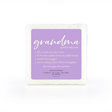 A soap-infused sponge with the word "Grandma" printed in the center, shown with rich, creamy lather.
