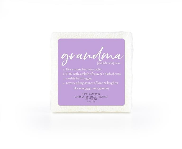 A soap-infused sponge with the word "Grandma" printed in the center, shown with rich, creamy lather.