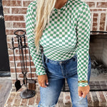 Green and white checkered mesh top with crew neck and long sleeves.