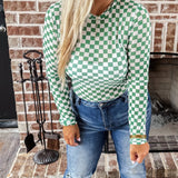 Green and white checkered mesh top with crew neck and long sleeves.