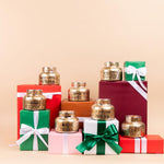Sweet Grace Holiday Candle display on Christmas boxes.