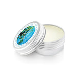 The .5 oz Inis Lip Balm in its compact, round aluminum tin.