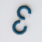 Candace navy hoop earrings with gold studs.