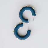 Candace navy hoop earrings with gold studs.