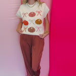 Lightweight knit sweater with rows of colorful pumpkins on a neutral base.