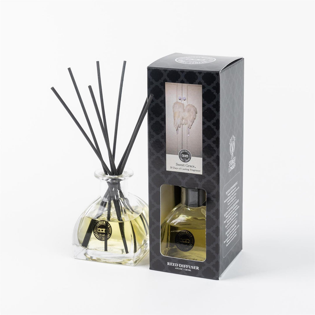 Sweet Grace Reed Diffuser in a clear glass bottle with black reeds, displayed alongside its packaging box.