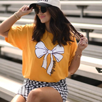 Gold Tultex tee with a white bow and bold black “game day” text at the bottom, displayed flat.