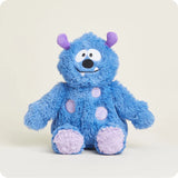 A soft, fuzzy blue plush monster toy with friendly eyes, small horns, and a wide smile, designed to be microwavable.