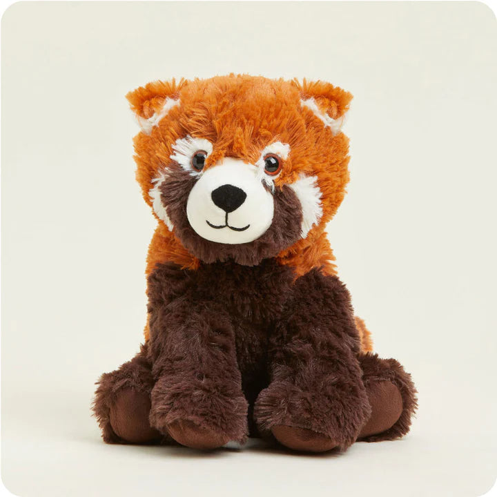 A soft, plush red panda toy with a striped tail and white facial markings, designed to be microwavable.
