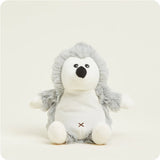 A small, soft plush hedgehog toy with textured grey "spines" and a white face, designed to be microwavable.