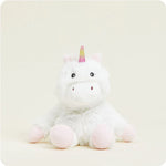 A small, soft plush white unicorn toy with a rainbow mane and tail and a sparkly horn, designed to be microwavable.